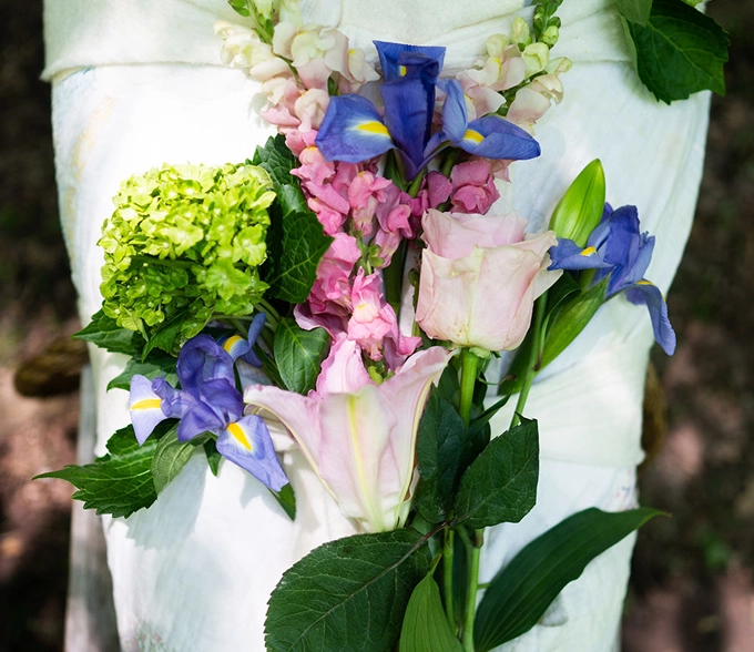 Flowers on ceremonial shrouded deceased.