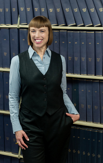  Kimberly Seaman Carter stands in front of a row of books in the library of John A. Gupton College where she teaches as a Mortuary Science Educator. 