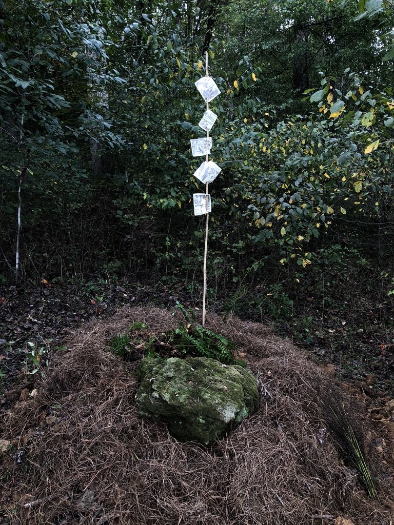  Finished grave with family photos on branch and rock on top. 