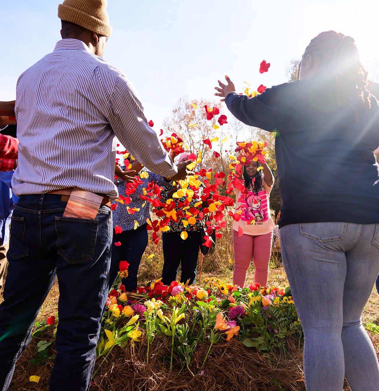 People throwing flower petals as a funeral omage
