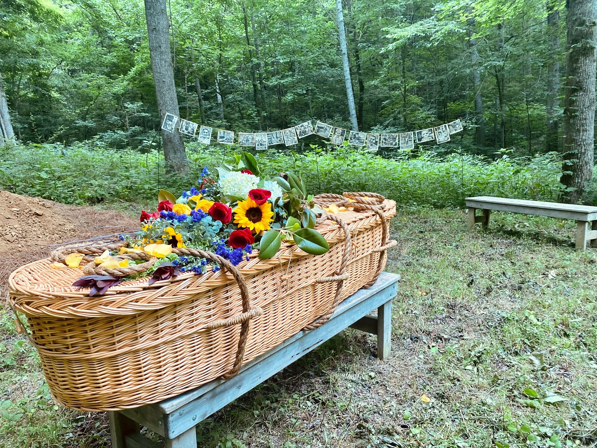  A biodegradable wicker basket casket is decorated with bright flowers during a natural, green burial at Larkspur. 
