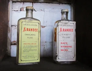 Two bottles of old embalming fluid